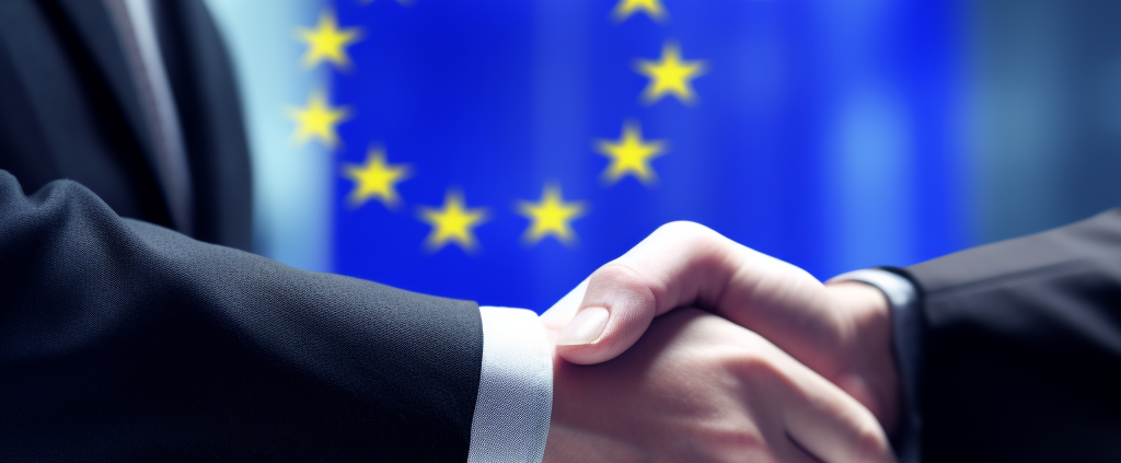 Zwei Hände werden geschüttelt um den Abschluss des Angemessenheitsbeschlusses zu besiegeln.